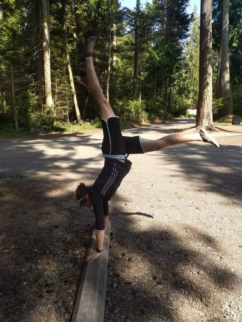 Erin doing a handstand on a wood curb at Salt Creek County Park.