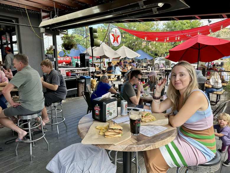 Andrea eating a sandwich at 11th Street Station in Durango, Colorado, which contained several food trucks.