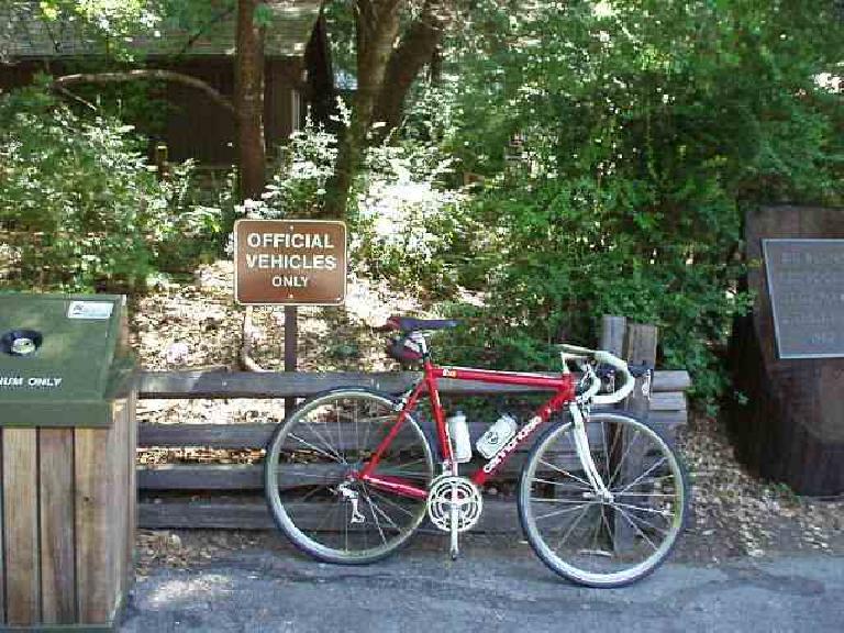 [Mile 54, 12:02 p.m.] "Official Vehicles Only" to me included my official steed of 10 years of ultra-cycling, Canny, my racy red Cannondale.  This is at the Big Basin Headquarters water/toilet stop.