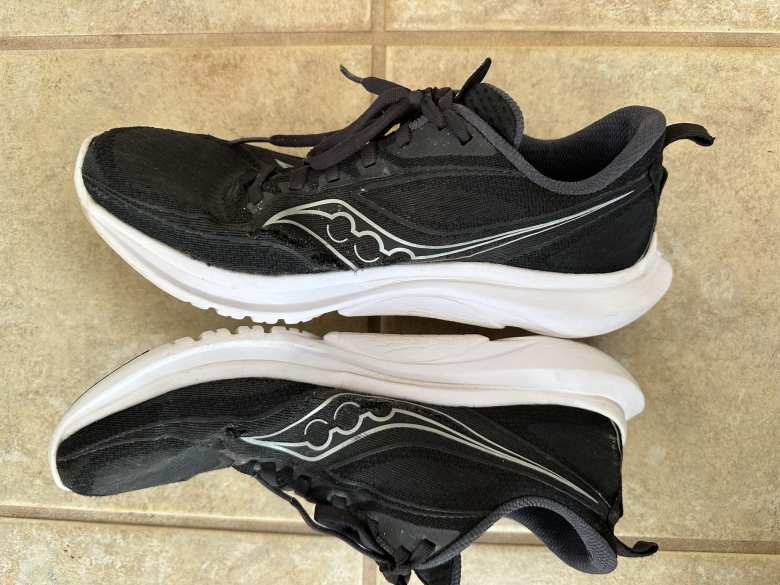 Black Saucony Kinvara 13 shoe after 660 miles. The lengthy stress tears in the uppers started to form after 250 miles.  They occurred only on the inner sides of the foot.