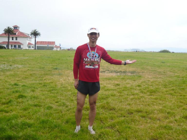 Felix Wong after the Alcatraz Challenge.  You can see Alcatraz a little bit above his hand in the distance.