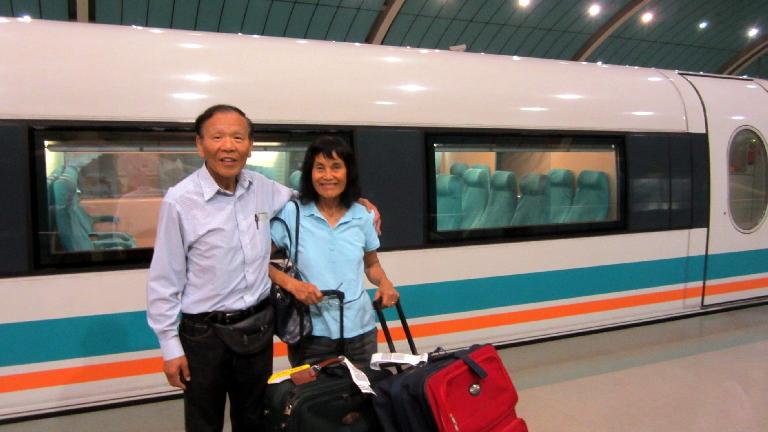 My dad and mom by the MagLev train, the fastest train in the world. It hit 300 kph while we were on it.