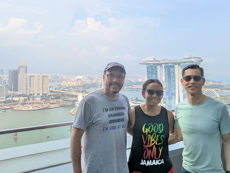 James, Leanne, and Felix on the balcony of LeVel33 with Marina Bay Sands in the background. 