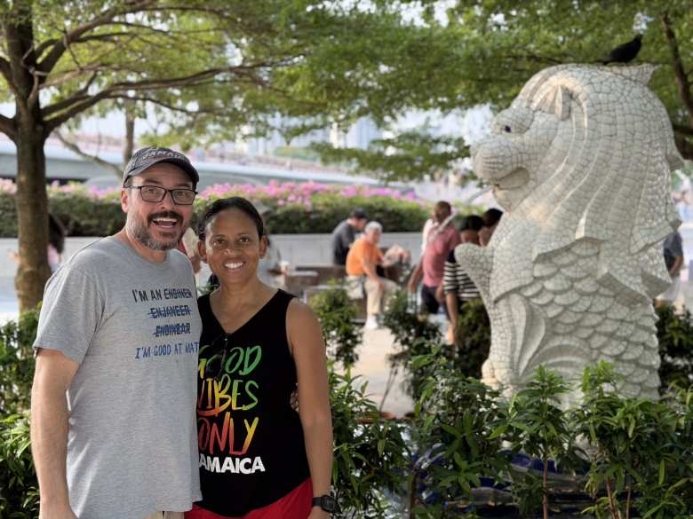 James and Leanne by a baby Merlion.