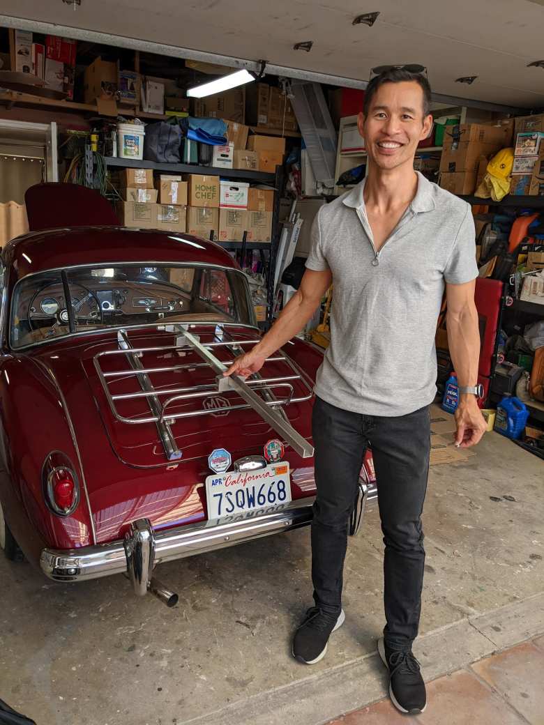 Felix Wong with a bicycle rack he designed and manufactured at Stanford University in 1996. It was designed for his MGB, but now Dan Shockey has it for use with his MGA.