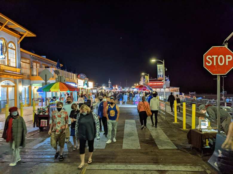 People walking at night at the Santa Monica Pier.