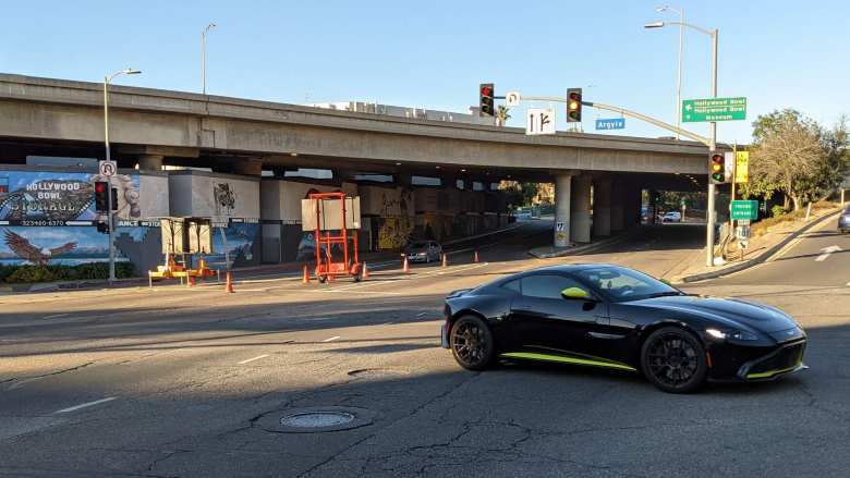 A black Aston Martin with green accents by US-101 in Hollywood, California.