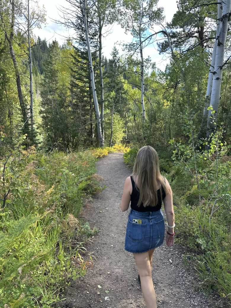 Andrea walking along a trail that went to the Fish Creek Falls parking lot.