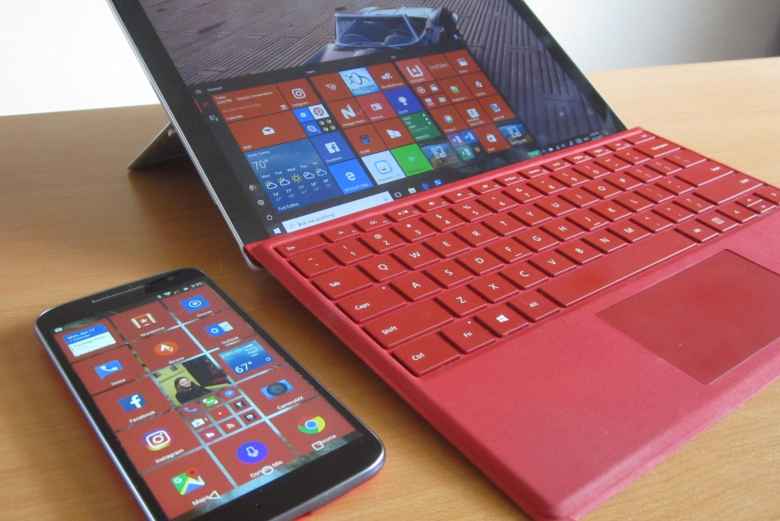 red Moto G4 with SquareHome 2, red Microsoft Surface Pro 4