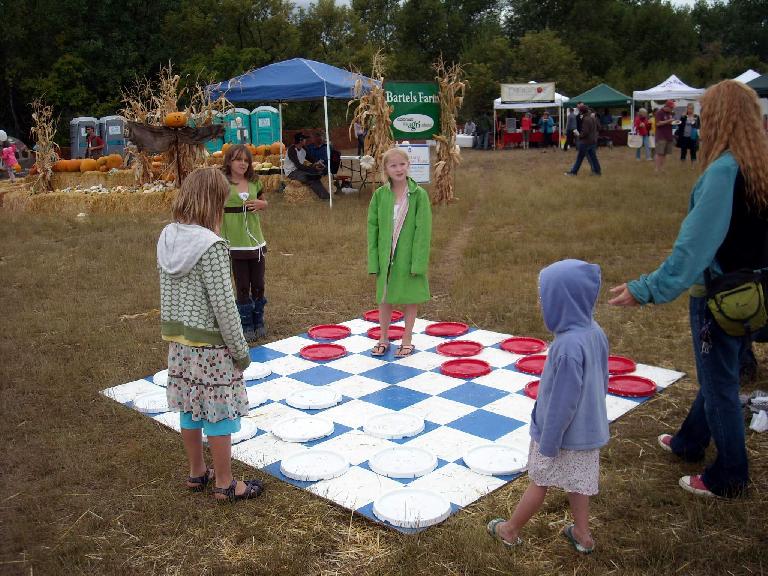 Kids playing a giant game of checkers.