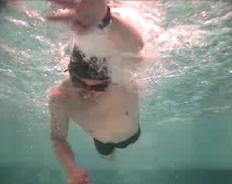 view of Felix Wong underwater with left arm extended.