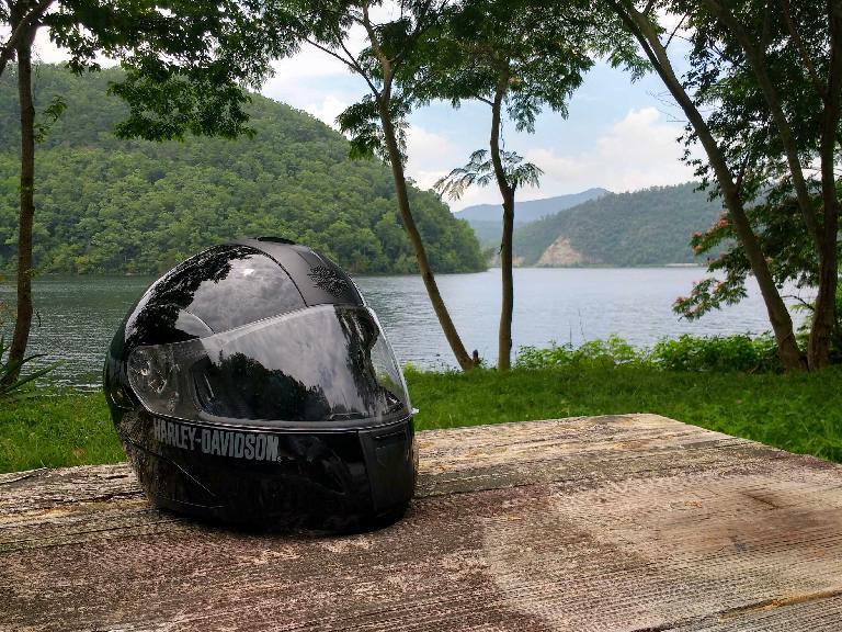 A black Harley-Davidson full-face helmet on a picnic table by Chilhowee Lake in Tennessee.