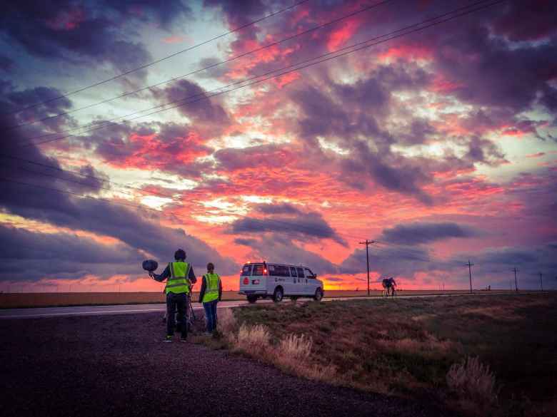A nice sunrise in Kansas while a person from Team Sea to See's media crew and Sheila Stevens (navigator) look on.