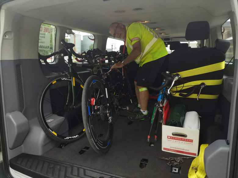 Steve O'Leary (assistant crew chief) securing tandem bicycles inside a van after a bike chain broke on the road.