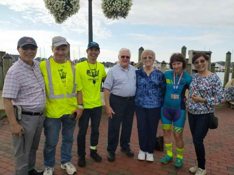 Jack Chen's father, Matt Hannifen, Felix Wong, the two parents of one of the riders, Tina Ament, and another family member or friend in Annapolis after the successful completion of the Race Across America.