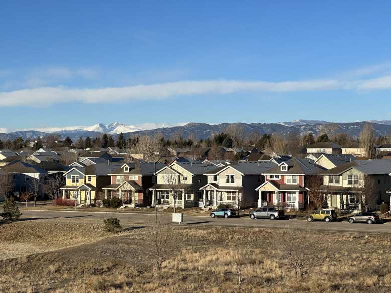 The homes of Brightwater Landing in Fort Collins, with snow-covered Longs Peak (elevation: 14,255 feet) and  Horsetooth Rock visible behind.