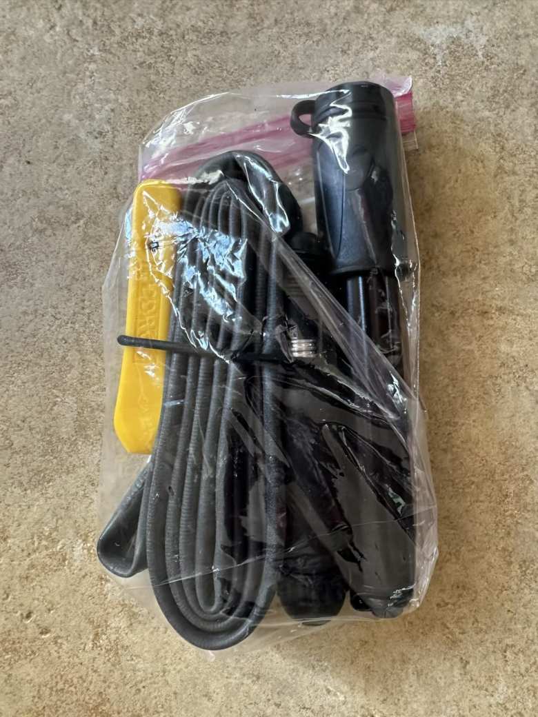 I bring Pedros mini tire levers, a spare tube, Dynaplug tire plugs, and a West Biking mini tire pump in a Ziplock bag and stash it in a rear jersey pocket.
