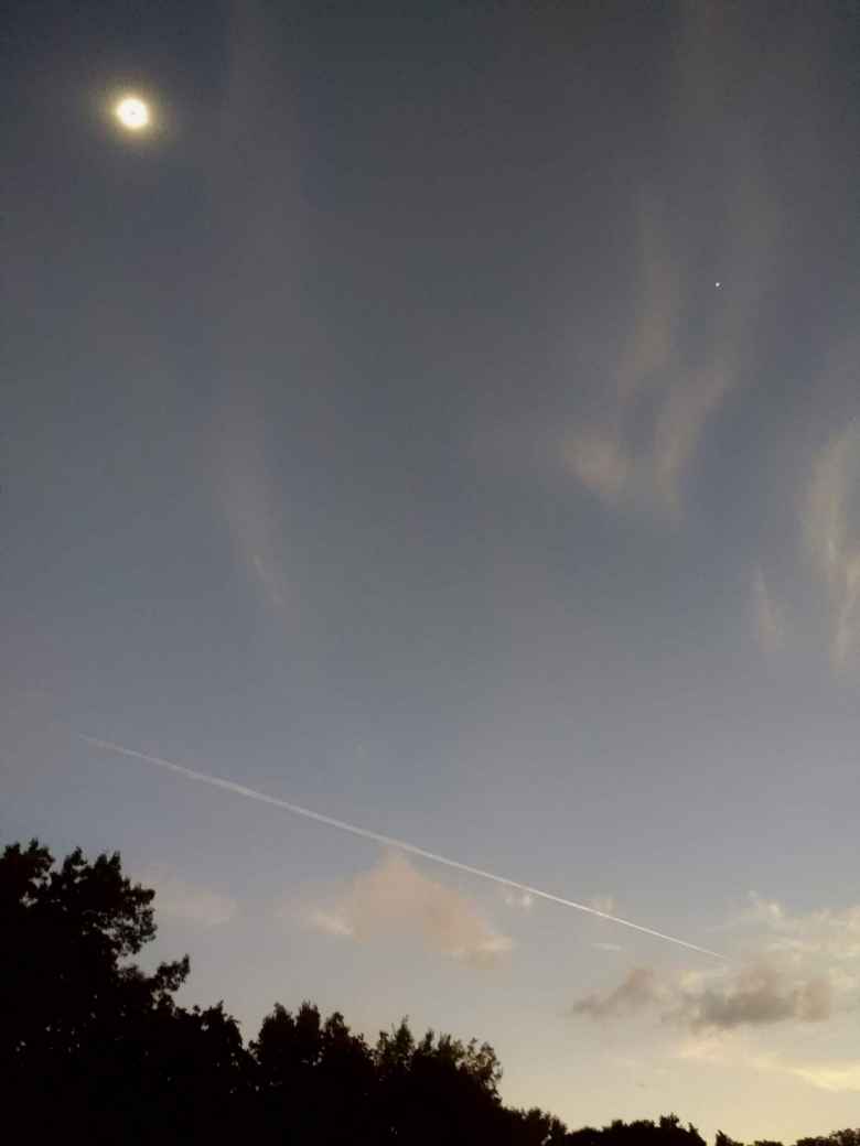 The sun's corona, Mercury, and a streak in the sky left by a plane during the total eclipse of 2017.