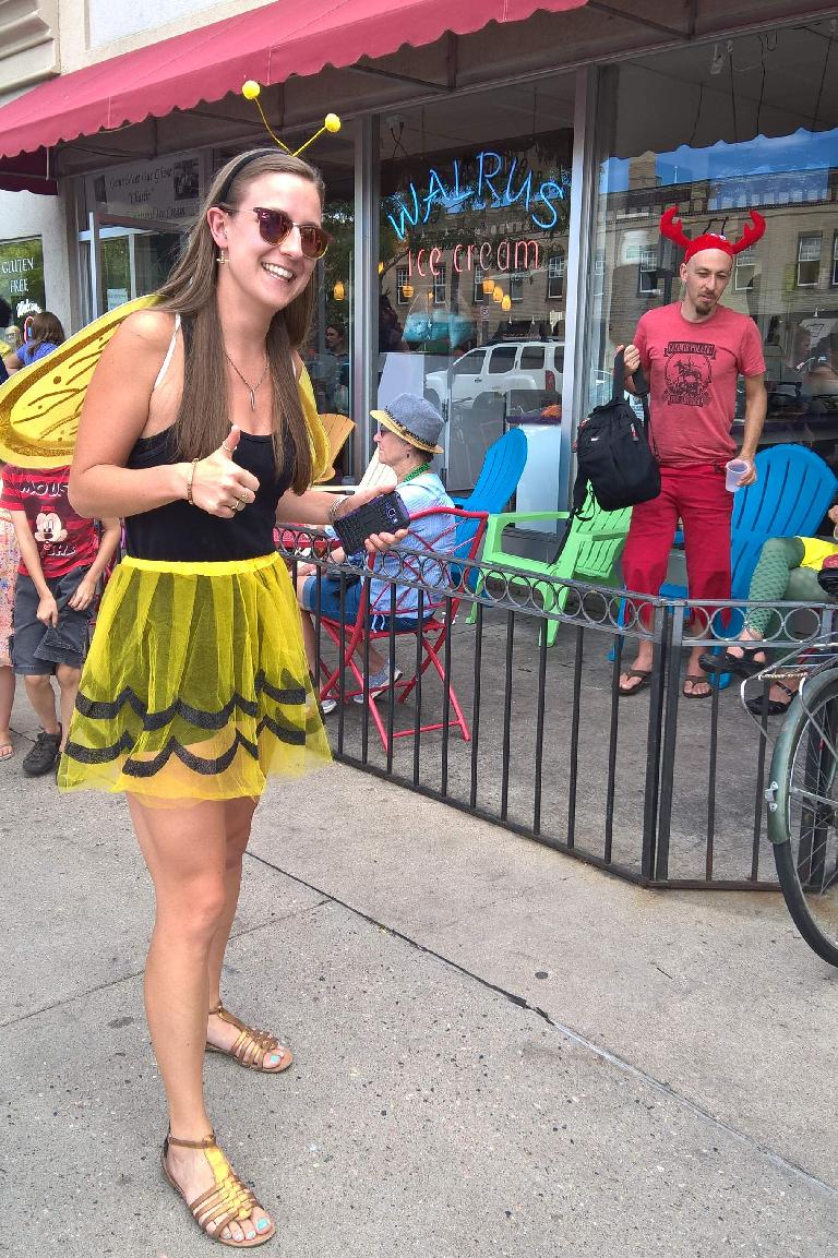 Olivia in a bee costume in front of Walrus Ice Cream.