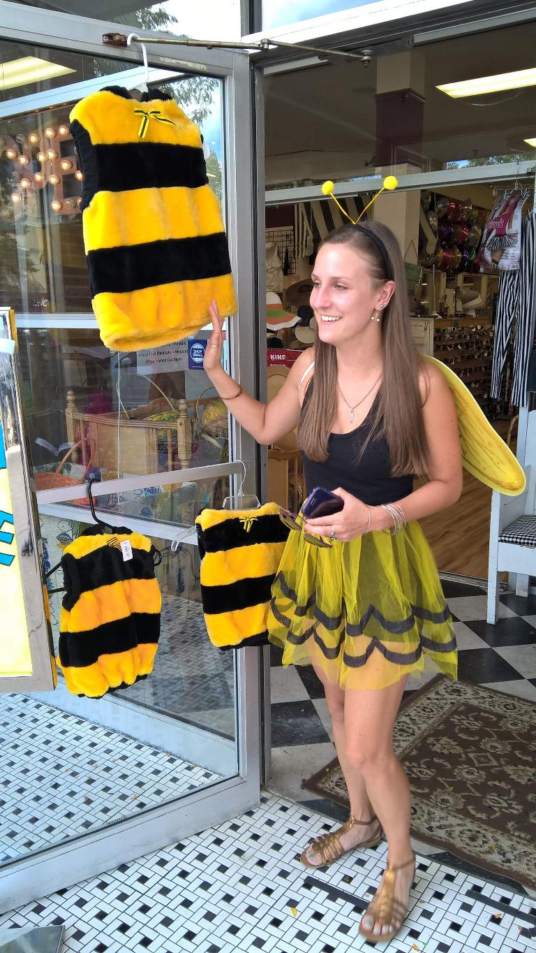 Olivia with other bee costumes at a shop along College Ave.