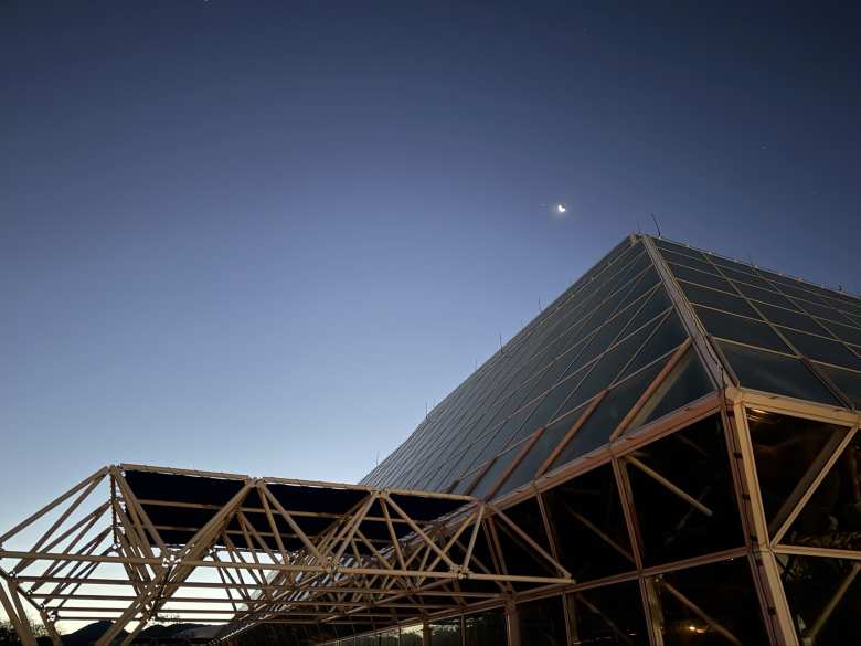A crescent moon loomed over Biosphere 2 before the start of the 2025 Tucson Marathon.