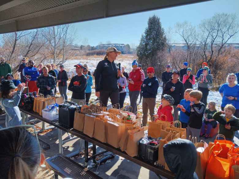 Melody, the organizer of the Turkey-Donut Predict 5k, announcing the winners of what must have been over 100 raffle prizes.