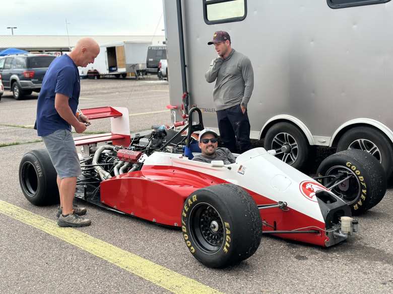 Manuel inside this ACL-Holden Formula 3000 race car from the 1980s. Dennis, the owner in the blue shirt, found it on Facebook Marketplace. Mike, in the grey shirt, is looking at the engine.