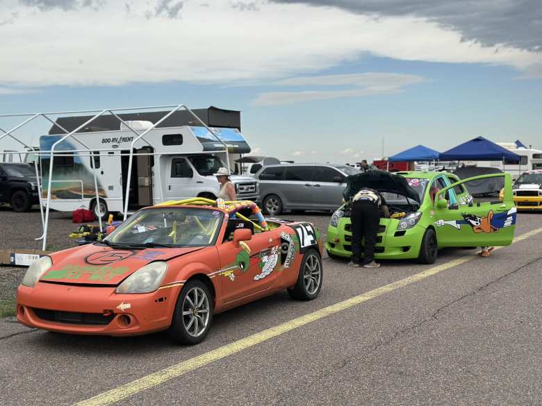 An orange Toyota MR2 Spyder and a green Toyota Yaris with a Daffy Duck theme. An orange Toyota MR2 Spyder and a green Toyota Yaris with a Daffy Duck theme.