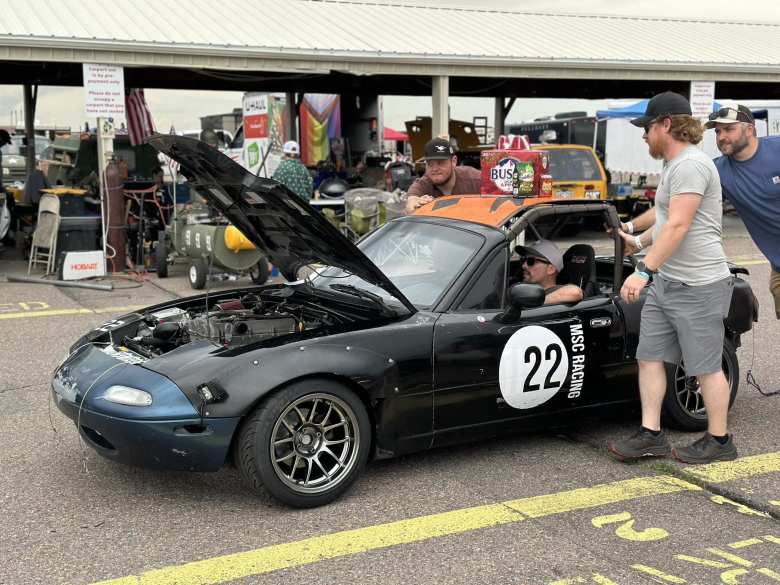 I found my friend Manuel inside of this black #22 Miata with an orange construction sign as the roof. I found my friend Manuel inside of this black #22 Miata with an orange construction sign as the roof.