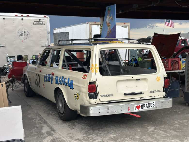 A Volvo 240 DL station wagon with a whale tail attached to the roof. A Volvo 240 DL station wagon with a whale tail attached to the roof.