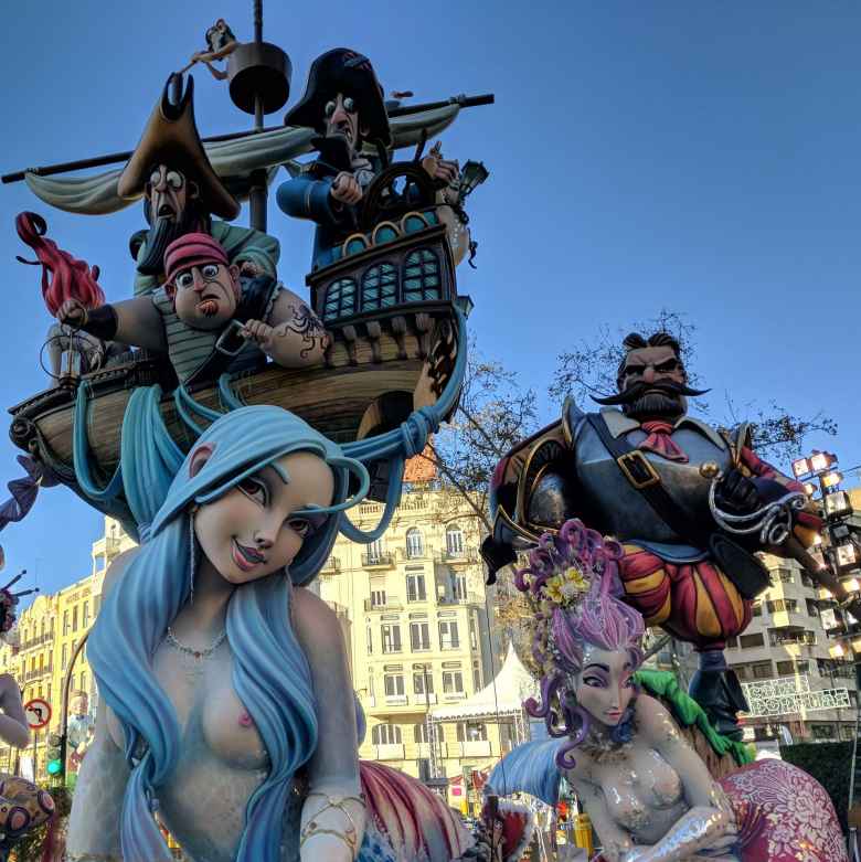 A falla of sailors gawking at a very attractive blue-haired woman.