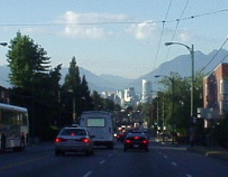 The modern, glassy Vancouver skyline is dwarfed by the granite mountains in the backdrop. The modern, glassy Vancouver skyline is dwarfed by the granite mountains in the backdrop.
