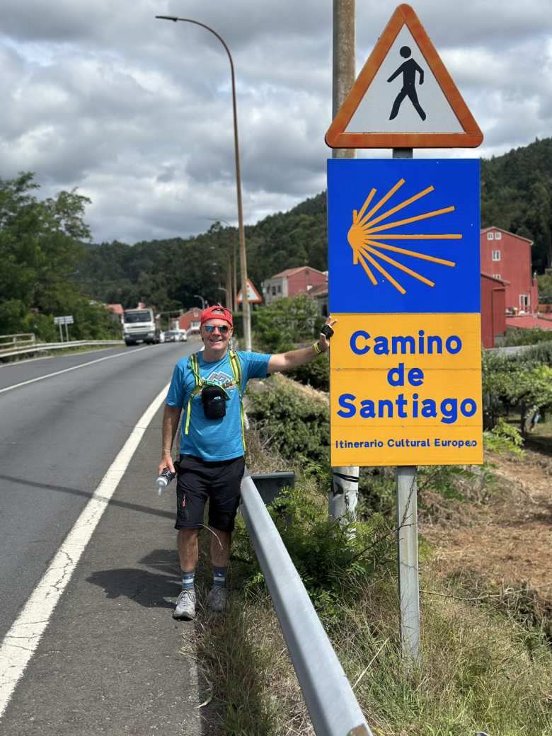 Eddie by a Camino de Santiago sign in Padrón.