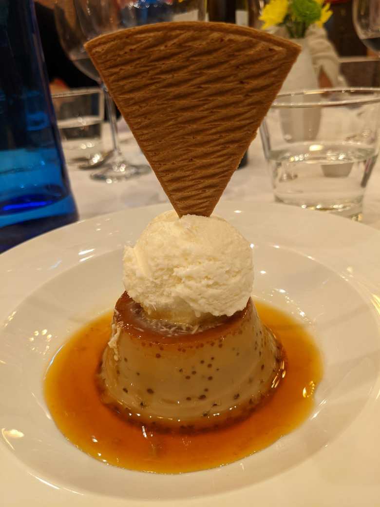 Flan with ice cream and a triangle cone.