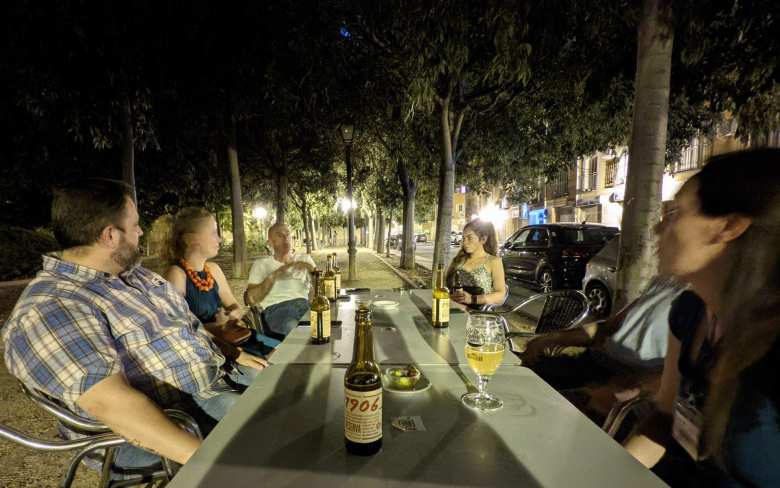 Victor, Lydia, Angel, Melissa, Ismael, and Nieves enjoying bottles of 1906 at night in Aranjuez. 