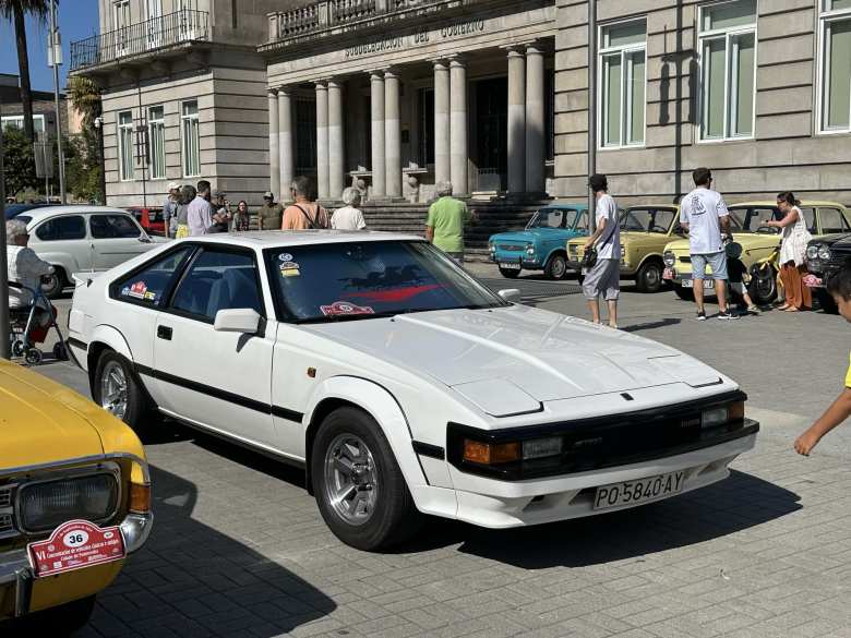 A white Toyota Supra from the early 1980s.