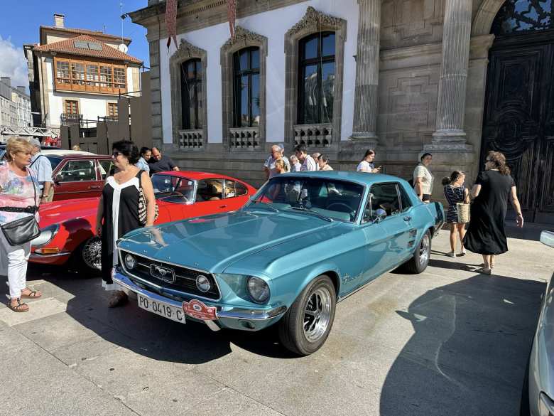 A first-generaiton Ford Mustang coupe.