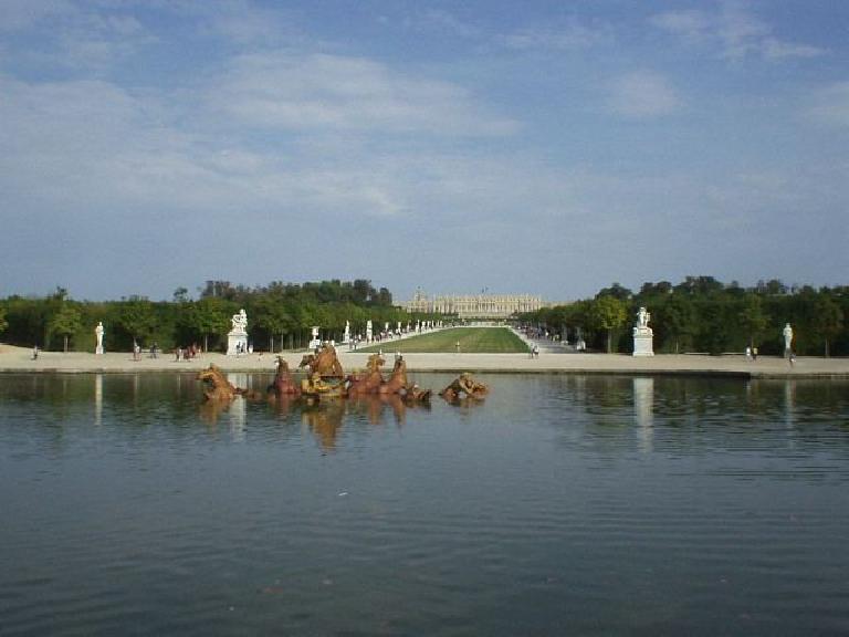 Small man-made lake (pond) with bronze, Apollo-like horse and chariot statues in the middle.  