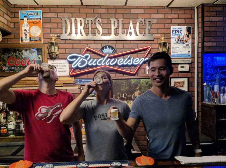 Manuel, Mel, and Felix drinking a mini-beer at Dirt's Place in Shenandoah, Iowa.