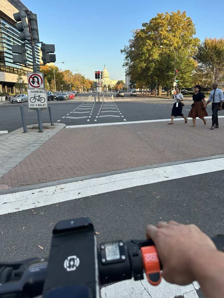 Riding a Spin electric scooter towards the Capitol building.
