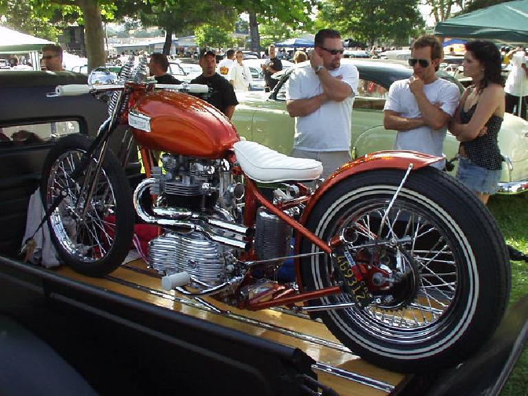 An elegant Triumph motorcycle on a pickup bed.