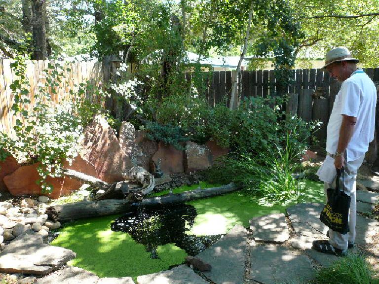 Stan examines a water feature at the Idea Wild Garden.