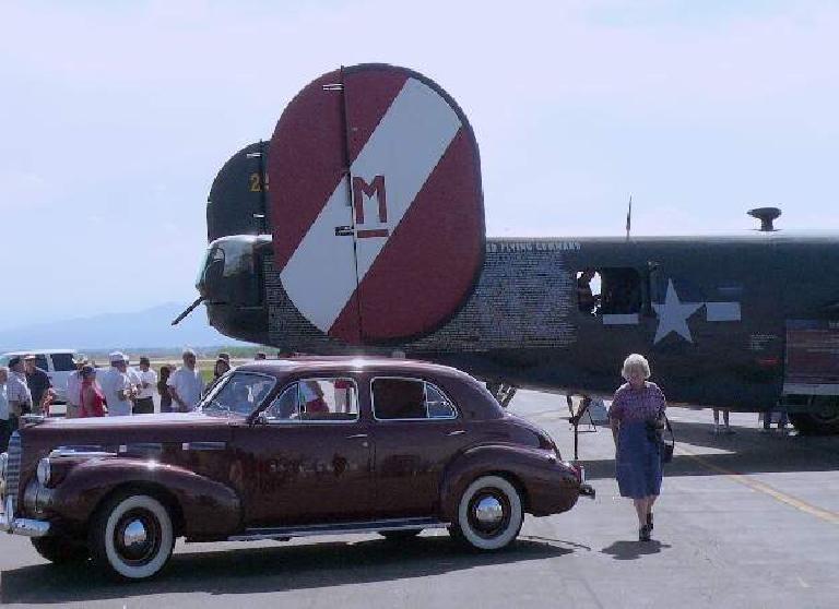 A LaSalle sedan in front of a B-24.