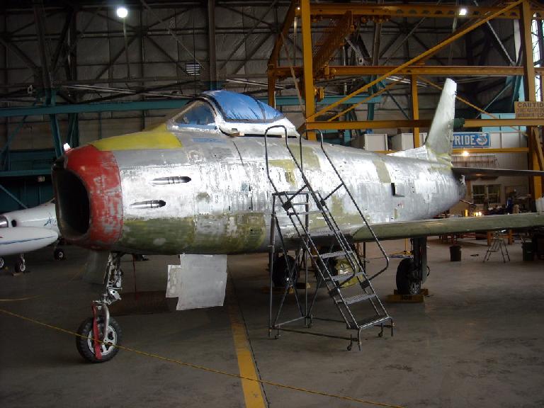 A plane under restoration inside the museum at the back.