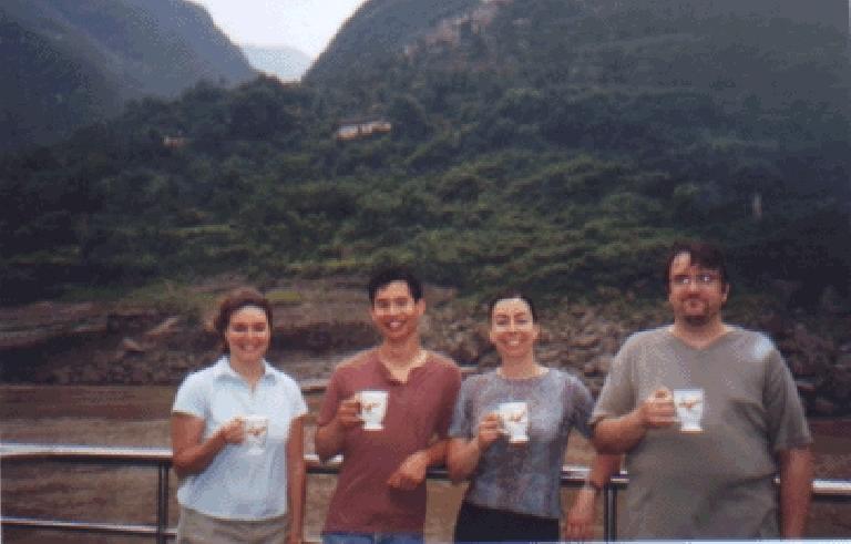 Karen, Felix, Martrese, and John drinking coffee or tea out of their "parting gifts".
