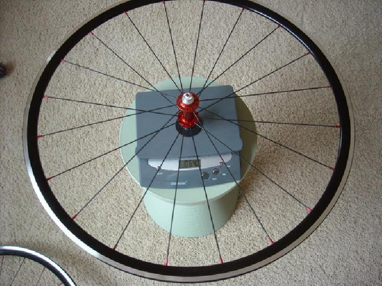 Front wheel: 640 grams (with rim tape; without skewers). The scale was tared with the black plastic piece holding the wheel horizontal so it is not included in the weight.