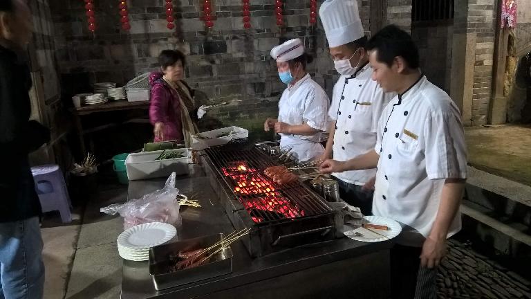 There were cooks barbecuing meat and vegetables inside the Yongding Hakka Tulou.