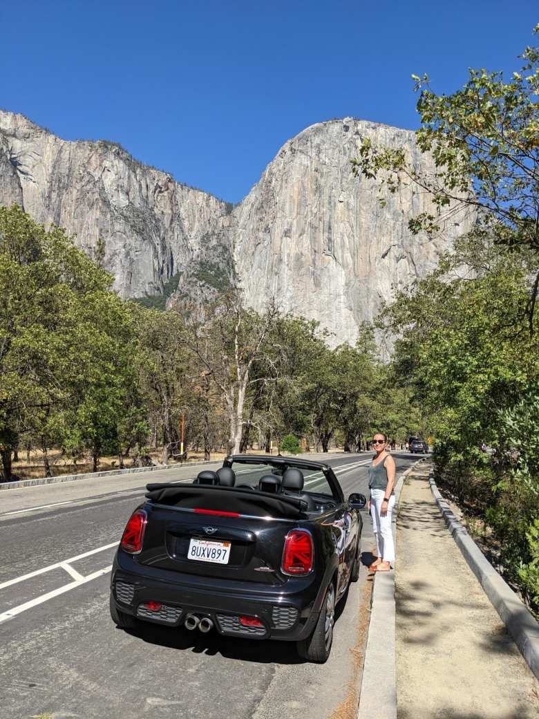 The black John Cooper Works edition MINI Convertible and Andrea in front of El Capitan in Yosemite Valley.